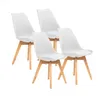 Four white dining chairs with wooden legs are arranged on a white background. Náhled obrázku produktu
