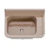A top-down view of a beige sink basin with a drain and a ribbed drying area on the right. Produktbild-Vorschau