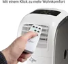 A hand holding a remote control points it towards a portable air conditioner. Produktbild-Vorschau
