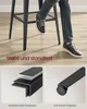 A person's legs and feet are shown sitting on a bar stool, with close-up diagrams of the stool's construction and feet. Produktbild-Vorschau