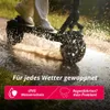 A person riding an electric scooter through a puddle, kicking up water. Produktbild-Vorschau