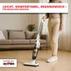 A person is vacuuming a living room floor with a stick vacuum cleaner. The sofa and a plant are visible in the background. Produktbild-Vorschau