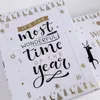 A close-up view of an open advent calendar with Christmas-themed decorations and text. Produktbild-Vorschau