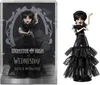 A Monster High doll of Wednesday Addams in a black dress, shown both in its packaging and displayed outside of it. Náhľad obrázku produktu