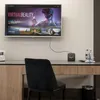 A television screen displaying a virtual reality interface is mounted on a wall above a desk with a small black media box, a telephone, and bottles of water. Anteprima dell’immagine prodotto