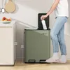 A person is shown using a green dual-compartment trash can in a kitchen setting. Náhľad obrázku produktu