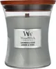 A WoodWick candle in a glass jar with a wooden lid. Voir les images du produit