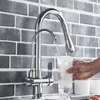A hand is holding a glass under a kitchen faucet, filling it with water. The faucet is mounted on a tiled backsplash. Náhľad obrázku produktu