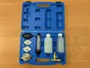 A blue plastic case containing a coolant system tester kit, laid open on a wooden surface. Podgląd zdjęcia produktu