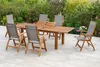 A wooden garden furniture set with chairs and a table placed on a patio surrounded by greenery. Náhled obrázku produktu