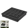 A black plastic cutlery organizer with multiple compartments is shown against a white background. A smaller inset image shows the organizer filled with cutlery on a table setting. Produktbild-Vorschau
