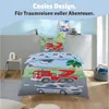 A child's bedding set featuring vehicles like a fire truck, police car, and helicopter, displayed on a bed in a room setting. Produktbild-Vorschau