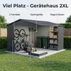 A garden shed with various items stored inside and around it, set in a grassy yard. Produktbild-Vorschau