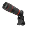 A black and red zoom telephoto lens with a clip attachment, isolated on a white background. Náhled obrázku produktu
