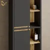 A close-up view of a modern bathroom cabinet with dark gray doors and open shelves made of wood-look material. A bottle of soap and a jar are visible on the shelves. Produktbild-Vorschau