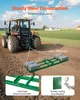 A tractor is pulling a green metal implement across a dirt field. There are houses in the background. Produktbild-Vorschau