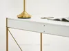 A close-up of a white desk with gold legs, showing a drawer and a lamp. Anteprima dell’immagine prodotto