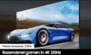 A blue sports car is shown on a screen, with a speedometer in the background. Text overlays indicate features. Produktbild-Vorschau