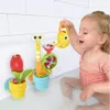 A young child playing with a bath toy in a bathtub. Podgląd zdjęcia produktu