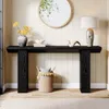 A black console table with decorative items and a basket underneath, set against a paneled wall with a round mirror above. Produktbild-Vorschau
