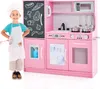 A child wearing a chef's hat and apron stands next to a pink toy kitchen. Produktbild-Vorschau