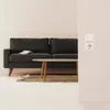 A living room scene with a sofa, coffee table, and electrical outlets. Produktbild-Vorschau