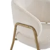 Close-up view of a cream-colored teddy fabric armchair with gold metal legs. Náhled obrázku produktu
