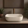 A modern bathroom vanity with a speckled beige vessel sink and a brass faucet. Anteprima dell’immagine prodotto
