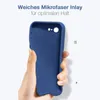 A hand holding a blue phone case against a white background. Produktbild-Vorschau