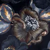 A close-up view of a dark floral pattern with metallic gold outlines. Produktbild-Vorschau