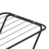A close-up view of the top section of a black clothes drying rack, showing the black metal frame and black lines, with two small orange plastic clips holding the lines in place. Anteprima dell’immagine prodotto