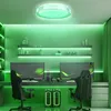 A modern gaming room setup with two computer stations, gaming chairs, and ambient green lighting. Náhled obrázku produktu