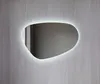 An illuminated, asymmetrically shaped mirror mounted on a textured gray wall. Anteprima dell’immagine prodotto