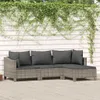 A grey rattan garden lounge set with dark grey cushions is placed on a wooden deck, with green ivy growing on a white wooden fence behind it. Podgląd zdjęcia produktu