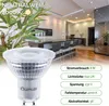 A close-up of an LED light bulb in front of a modern kitchen setting. Produktbild-Vorschau