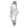 A silver Guess watch with a floral patterned face and crystal embellishments on a white background. Produktbild-Vorschau