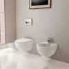 A modern bathroom with a wall-mounted toilet and bidet. Anteprima dell’immagine prodotto