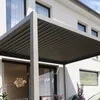 A modern house with a gray pergola over a patio. Anteprima dell’immagine prodotto