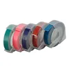 A set of five rolls of colored embossing tape in clear plastic holders, arranged in a row against a white background. Voir les images du produit
