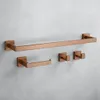A set of copper-colored bathroom accessories mounted on a gray concrete wall. Anteprima dell’immagine prodotto