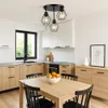 A modern kitchen with wooden cabinets, white upper cabinets, and a dining table with chairs. Produktbild-Vorschau
