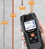 A hand holds a MAKA® wall scanner device in front of a wall with various pipes and a rebar, with measurement indicators. Podgląd zdjęcia produktu