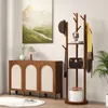 A wooden coat rack with shelves and hooks stands next to a wooden cabinet with arched doors, in a room with a painting on the wall. Anteprima dell’immagine prodotto