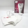 A Philips epilator and its accessories are laid out on a white surface, with the product's packaging in the background. Náhled obrázku produktu