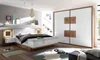 A modern bedroom with a bed and a large wardrobe. Produktbild-Vorschau