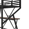 A close-up view of the metal frame and wooden shelf of a loft bed with a desk. Voir les images du produit