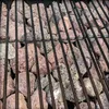 A close-up view of lava rocks on a grill. Produktbild-Vorschau