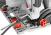 A close-up view of a hand tool and red knobs on a gray base of a power tool. Náhľad obrázku produktu
