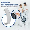 A mother and daughter are sitting on washing machines, with a close-up of a washing machine door handle. Produktbild-Vorschau