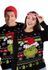 A man and a woman wearing matching Grinch-themed Christmas sweaters against a white background. Produktbild-Vorschau
